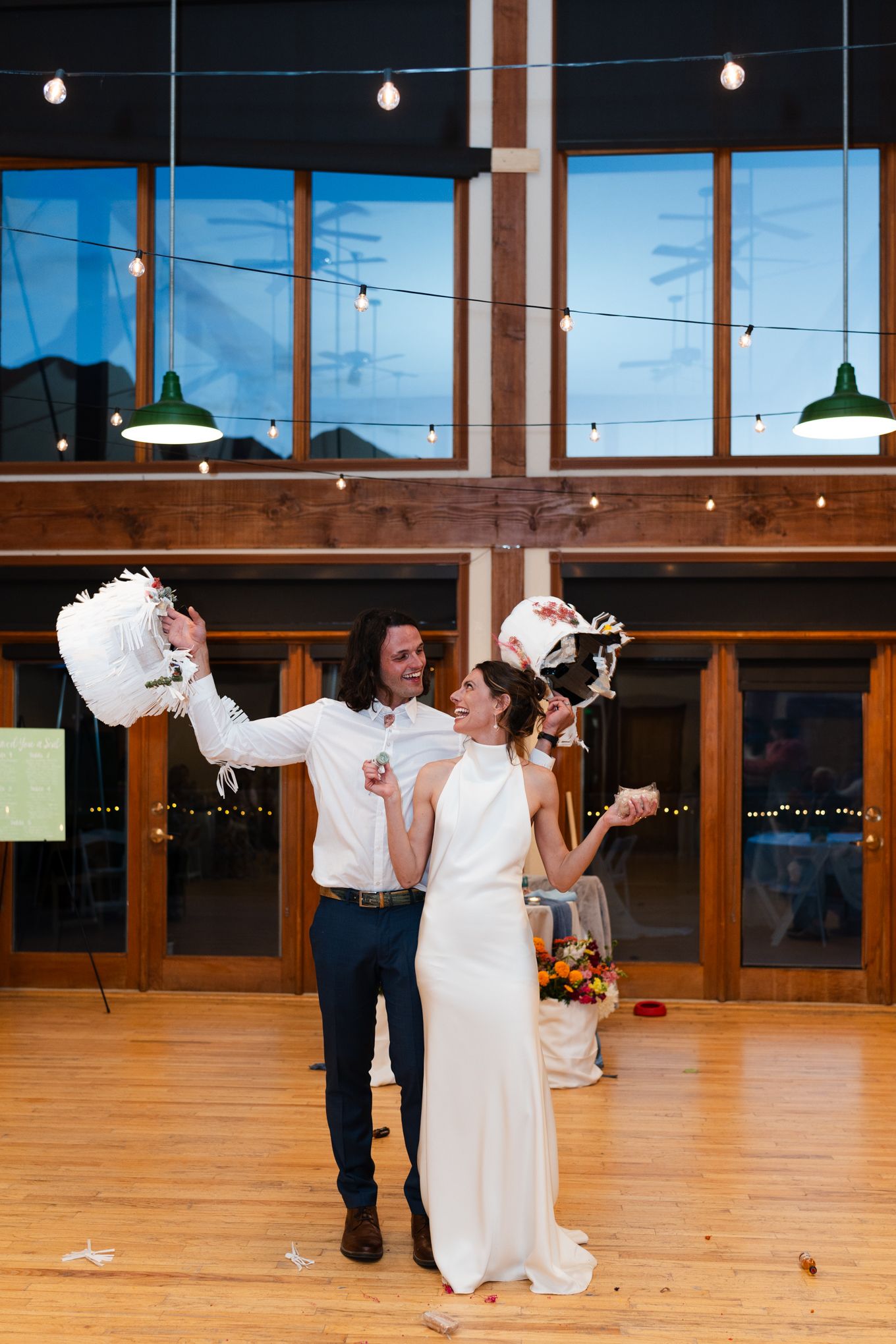 Celebration in a modern venue with wood beams and pendant lights.