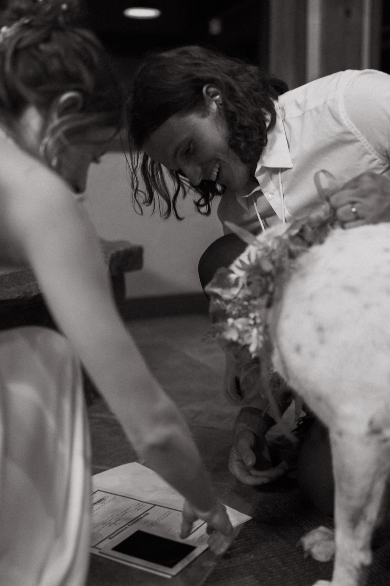 Black and white candid moment during wedding reception celebrations.