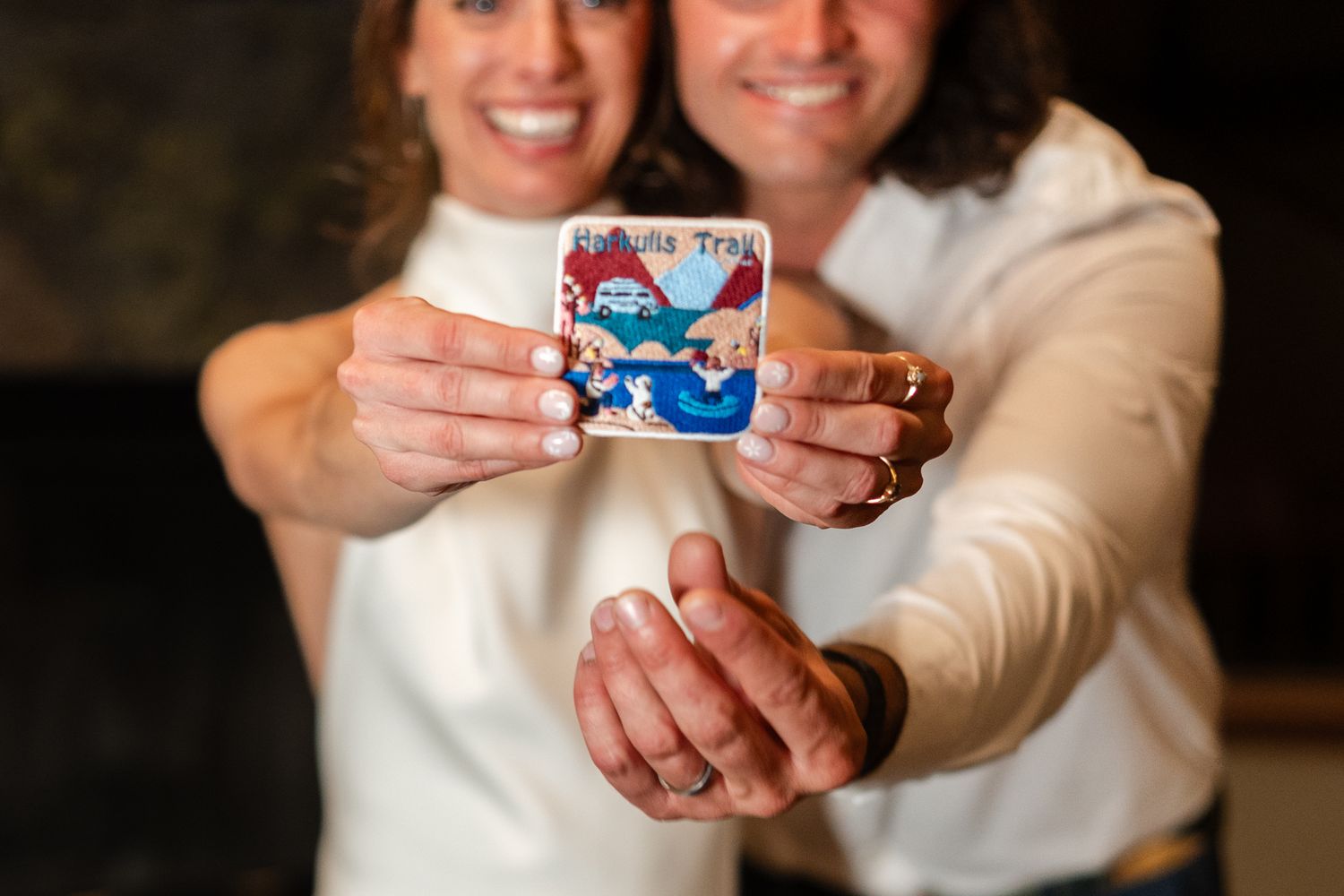 A couple holds up a small patch together