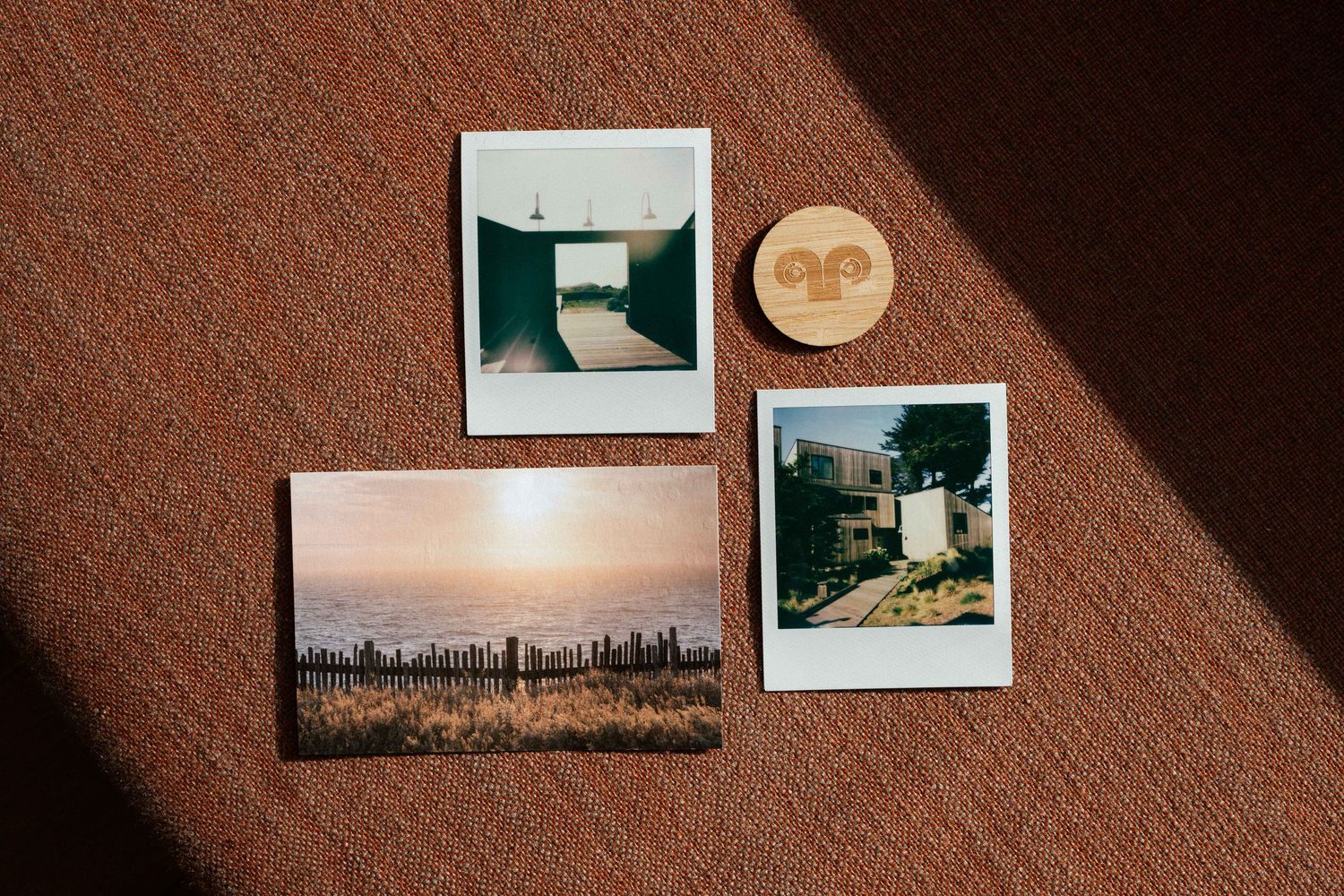 Sea Ranch Lodge flat lay with Polaroid photographs, a postcard, and a room key.