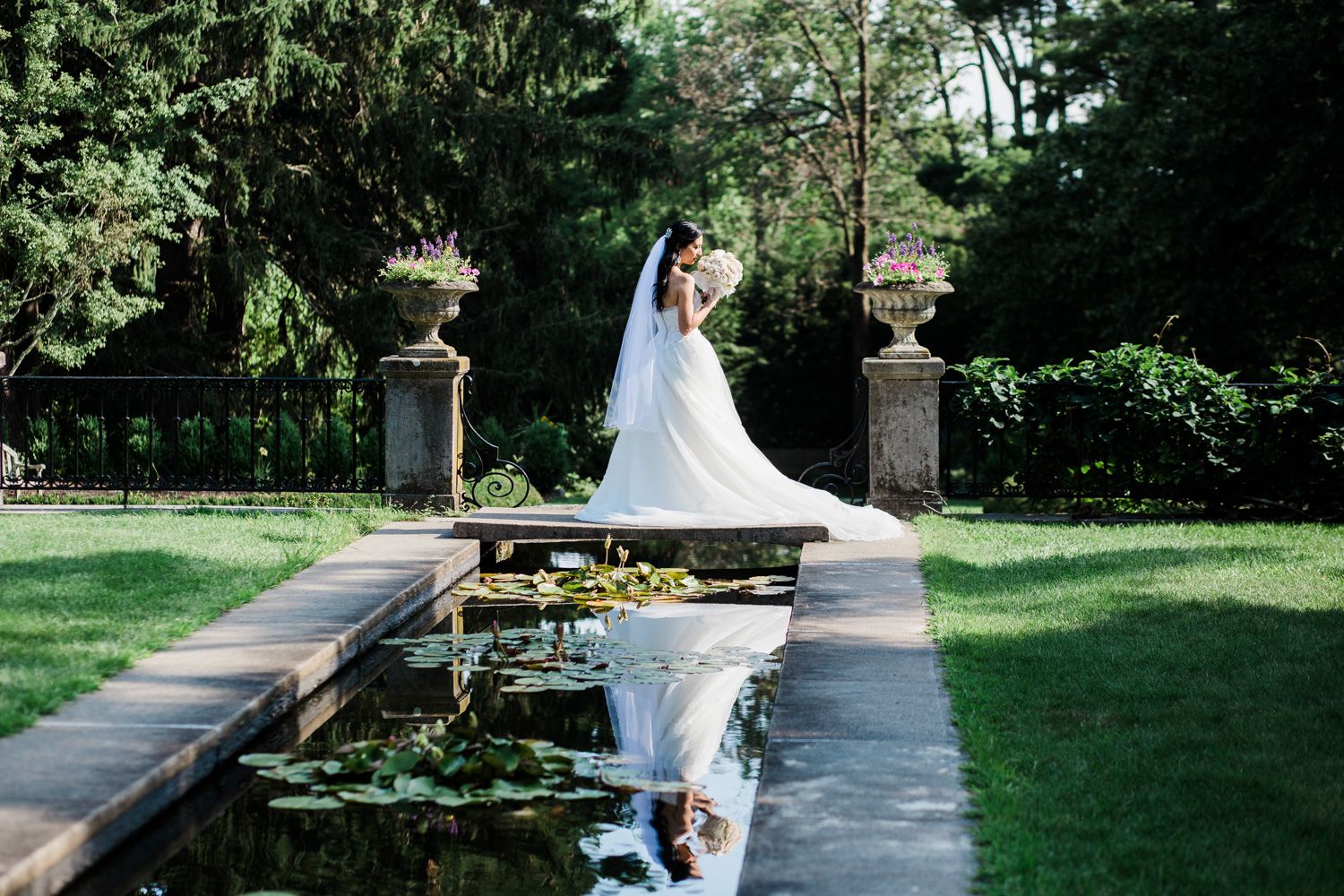 Bride reflected in pool at Skylands Manor