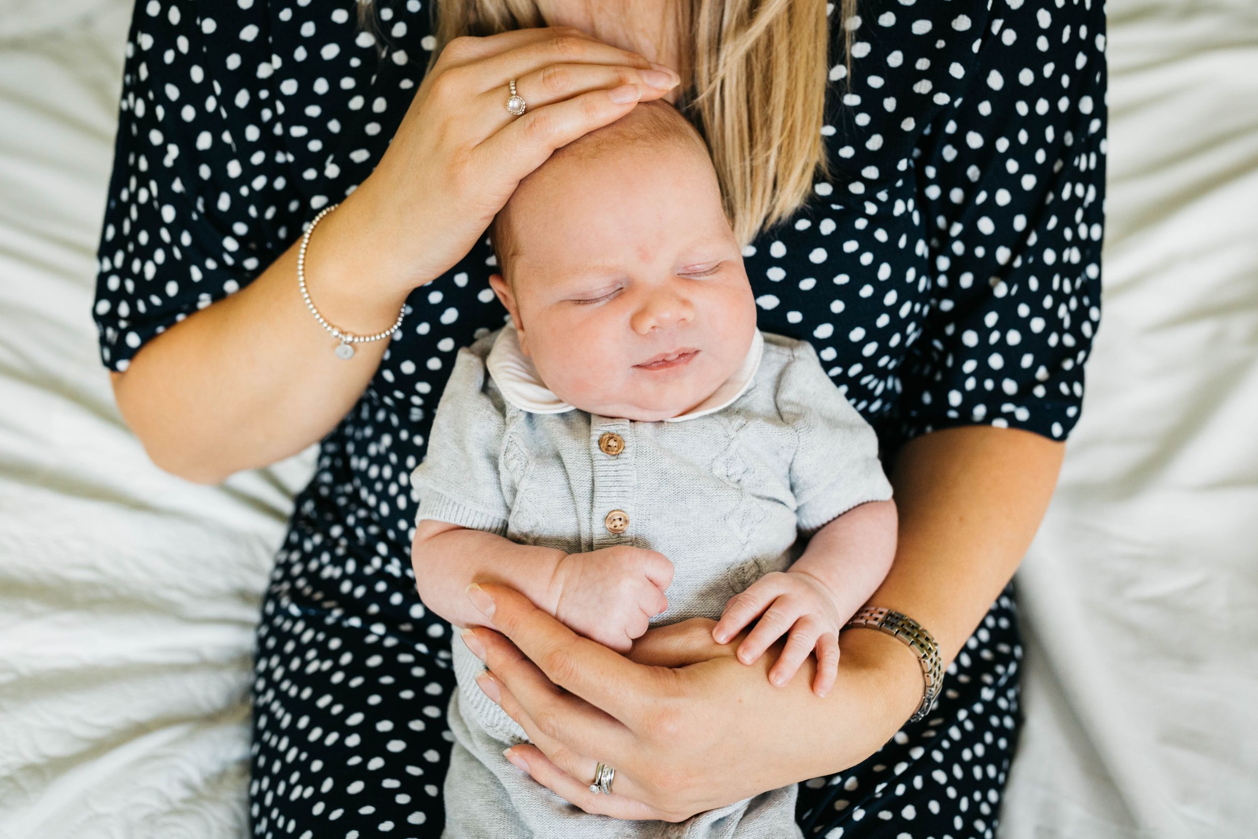 baby boy closed eyes close to mum chest