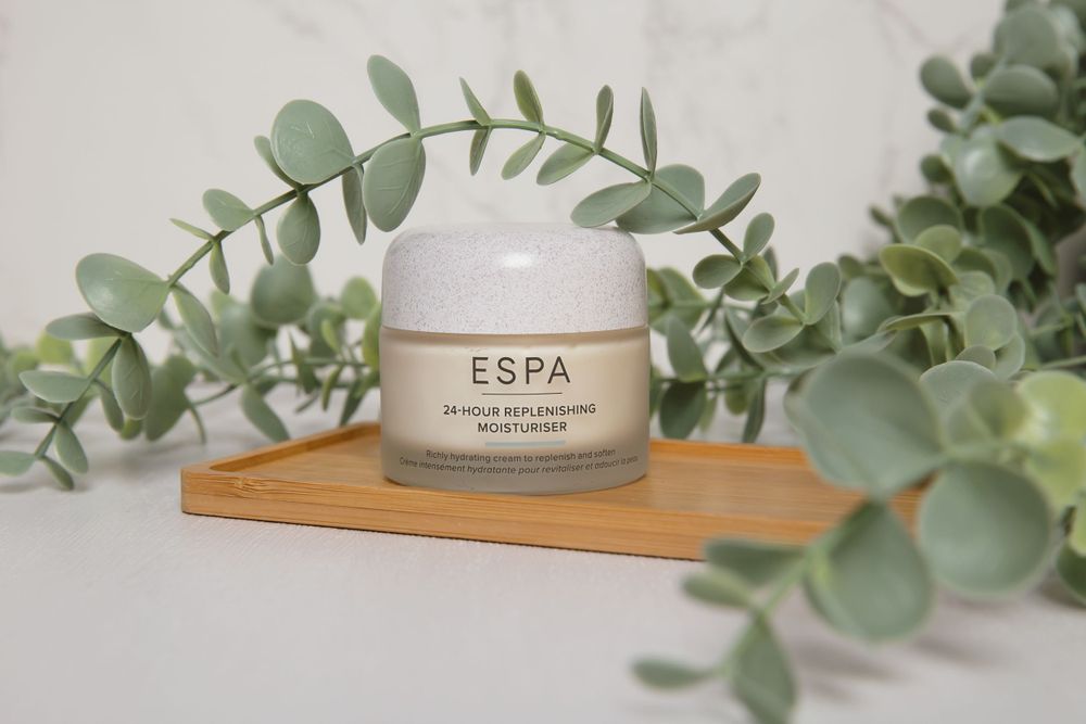 espa cream on wooden tray surround by leaves