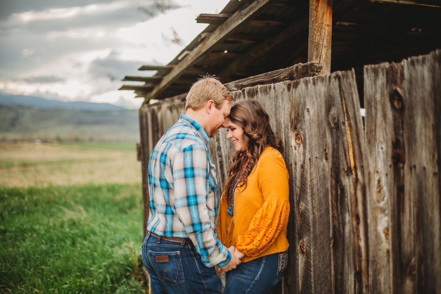 A couple gazes at eachother during their Colorado engagement session at Reservoir Ridge Natural Area in Fort Collins, CO