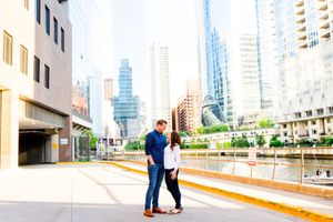 man and woman smiling at each other in front of Chicago River near Kinzie St Bridge