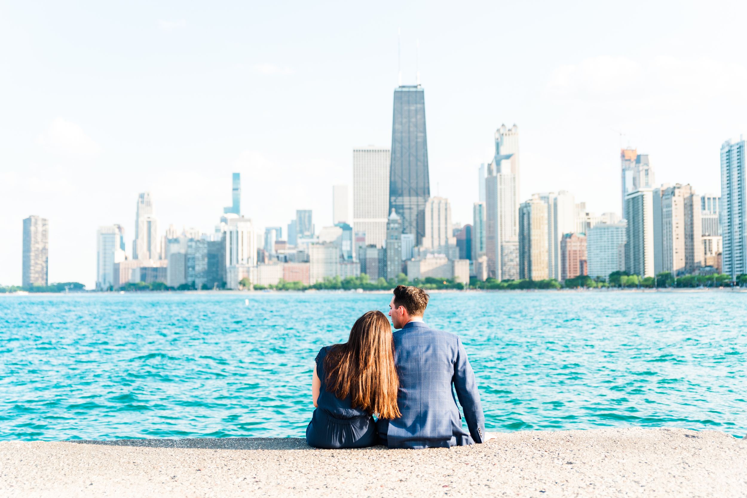 man and woman sitting in front of Hancock tower after North Avenue Beach proposal