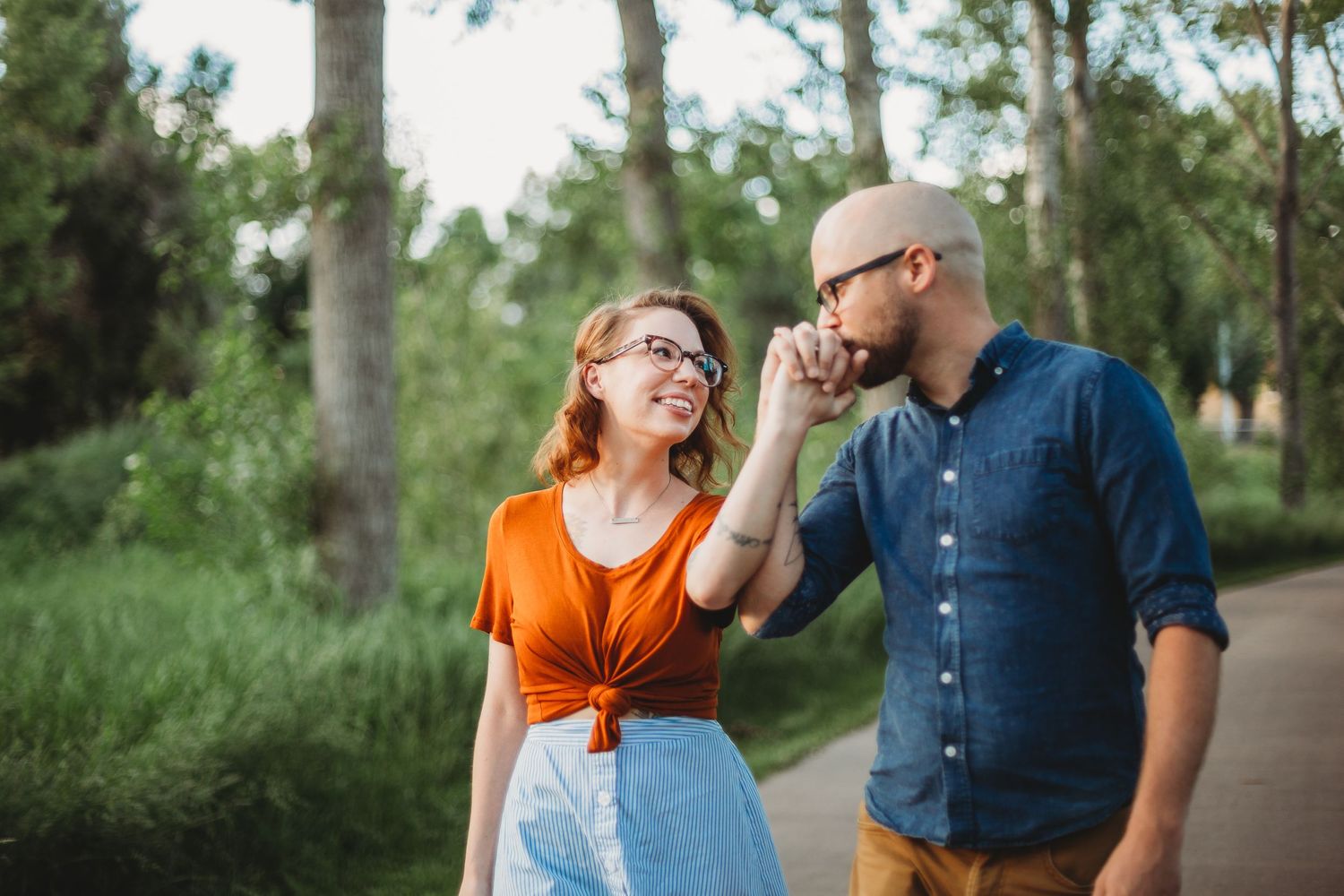 A couple walks along the path at Ross Natural Area during their portrait session in Fort Collins, Colorado.
