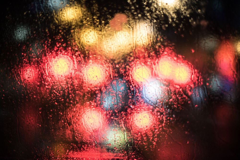 Colorful lights through a windshield on a rainy London evening