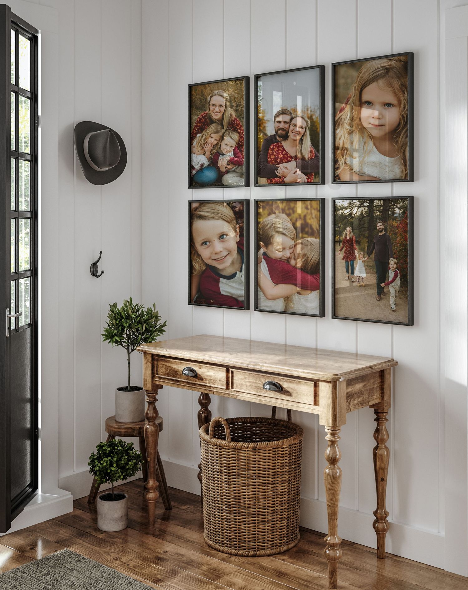 A rustic entryway features a farmhouse console table, woven basket, and gallery wall of framed photos against white walls.