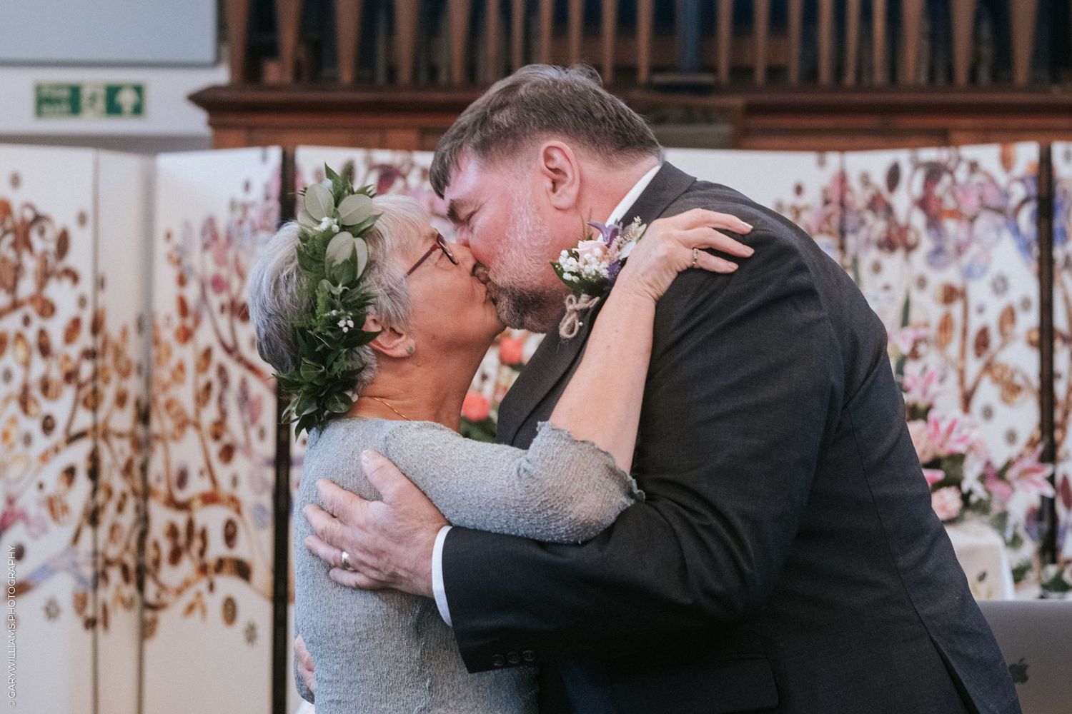 Documentary wedding photography of a bride and groom kissing at Sutton St. James Baptist Church