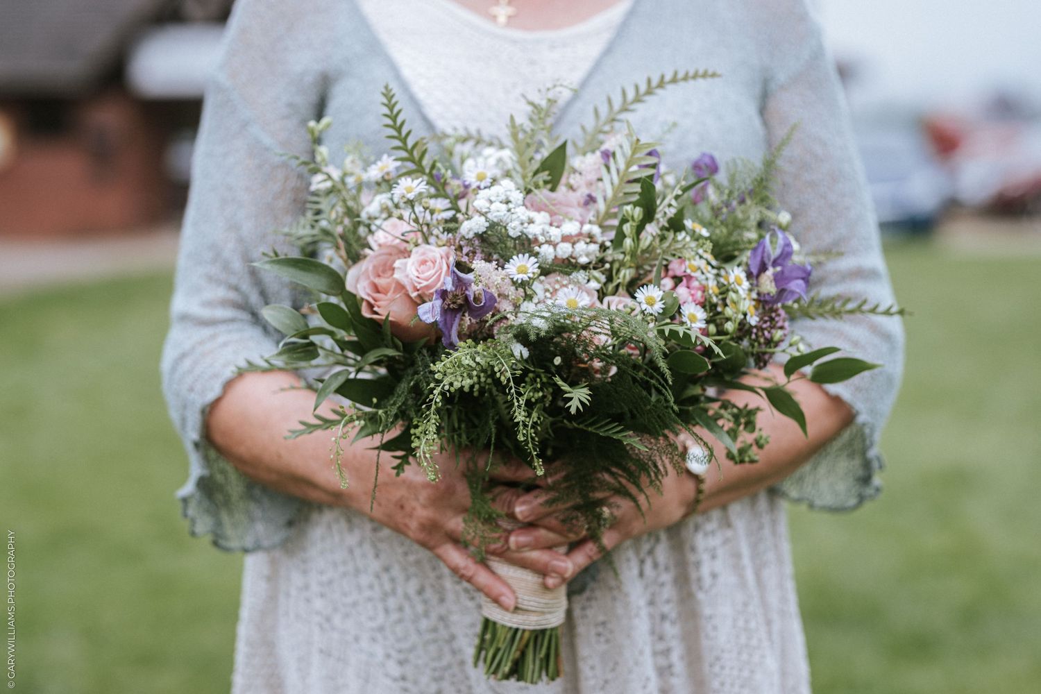 Documentary wedding photography of a bride holding her bouquet