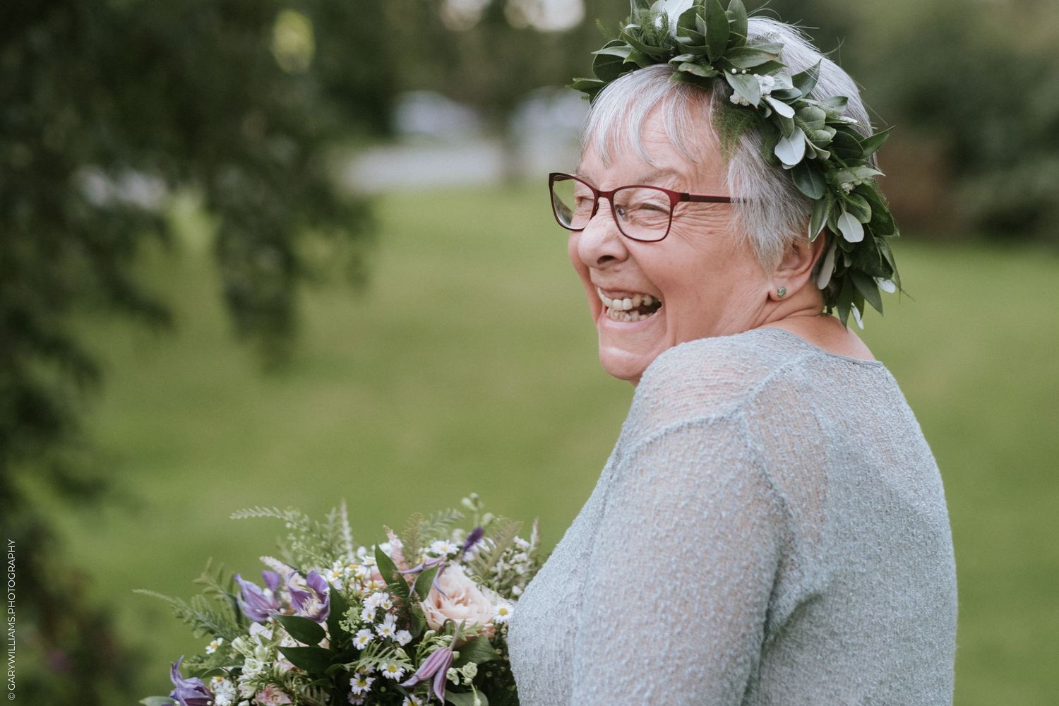 Documentary wedding photography of a bride laughing at Sutton St. James Baptist Church in Lincolnshire