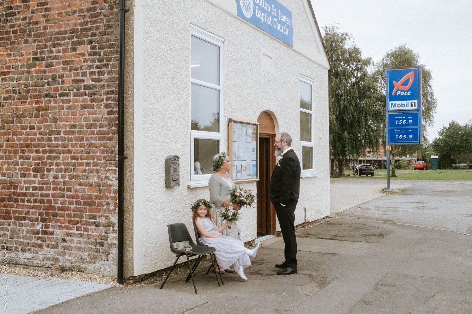 Documentary wedding photography of a bride outside of Sutton St. James Baptist Church in Lincolnshire