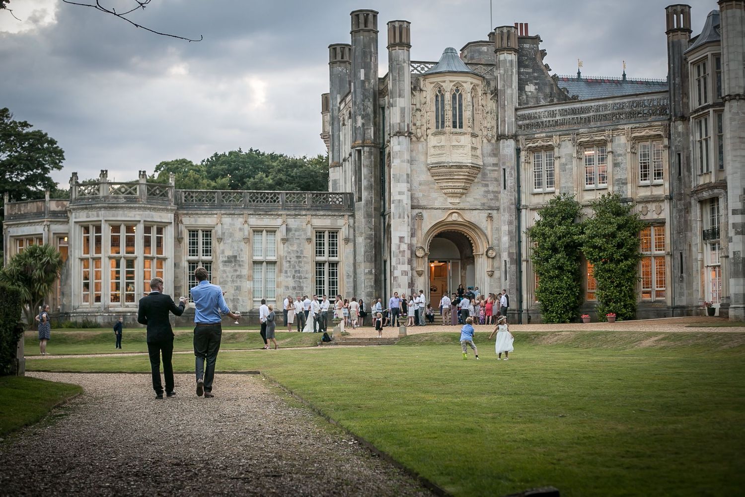 Wedding party guests enjoy the gardens of Highcliffe Castle