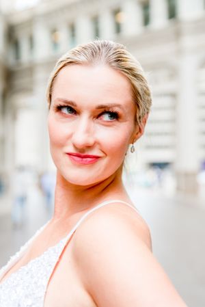 blonde woman in silver sequin dress under Wrigley Building after downtown Chicago elopement
