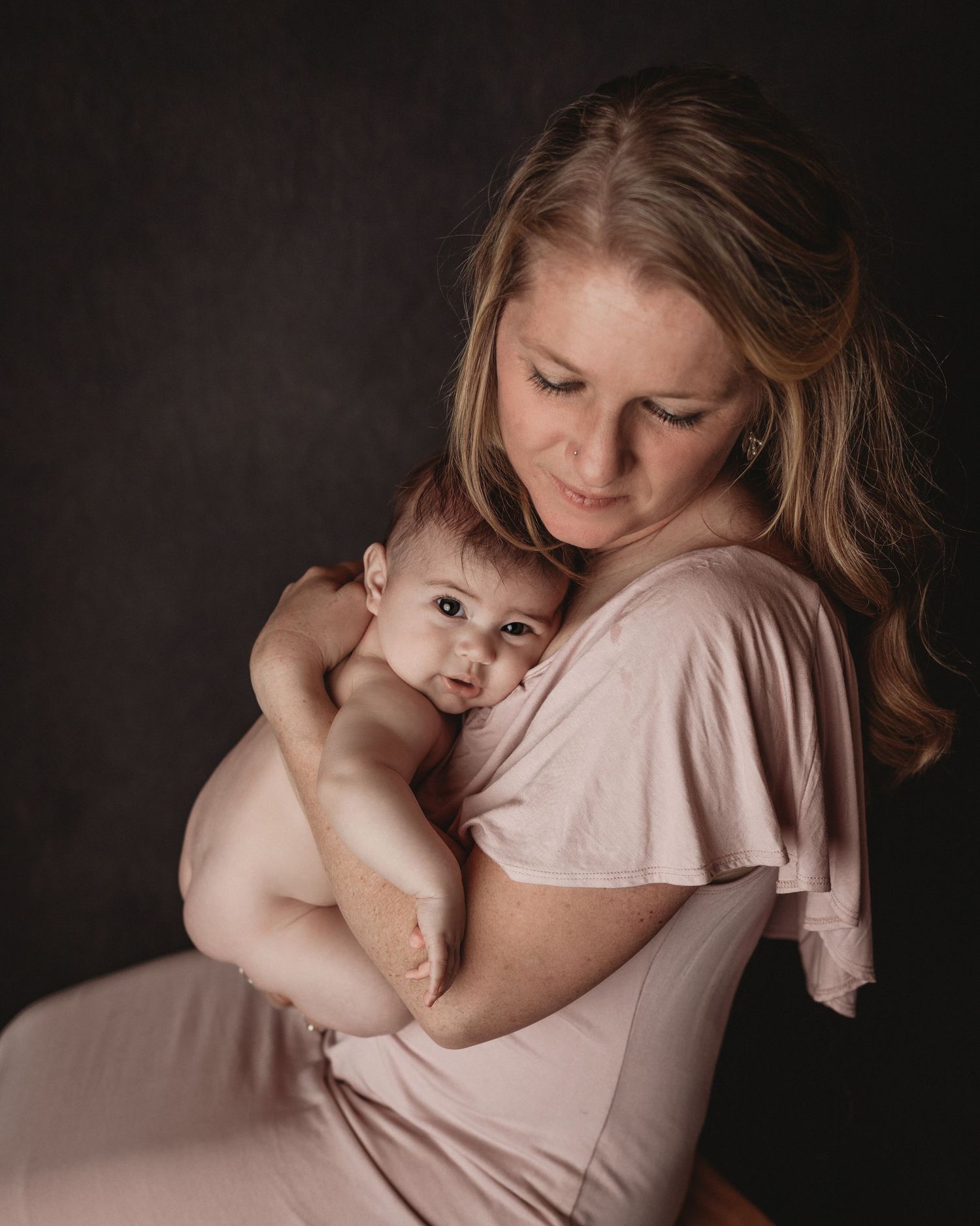 mom and baby mom and daughter snuggling studio photography pink dress