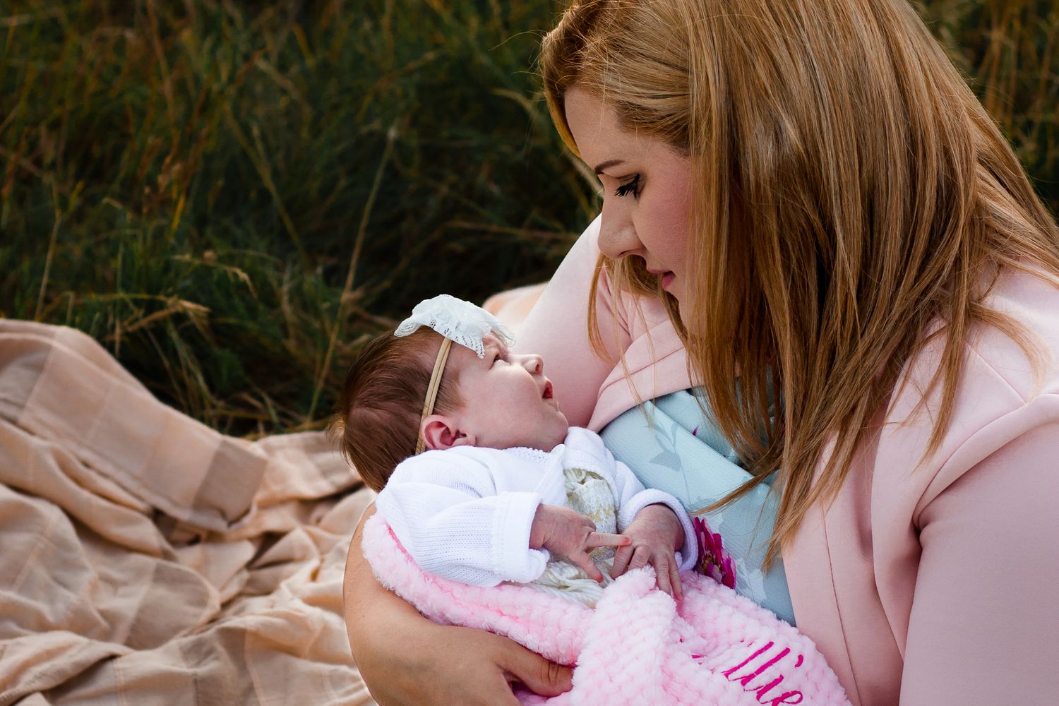 In a field in Havant a new Mum sits staring adoringly down at her newborn baby girl.