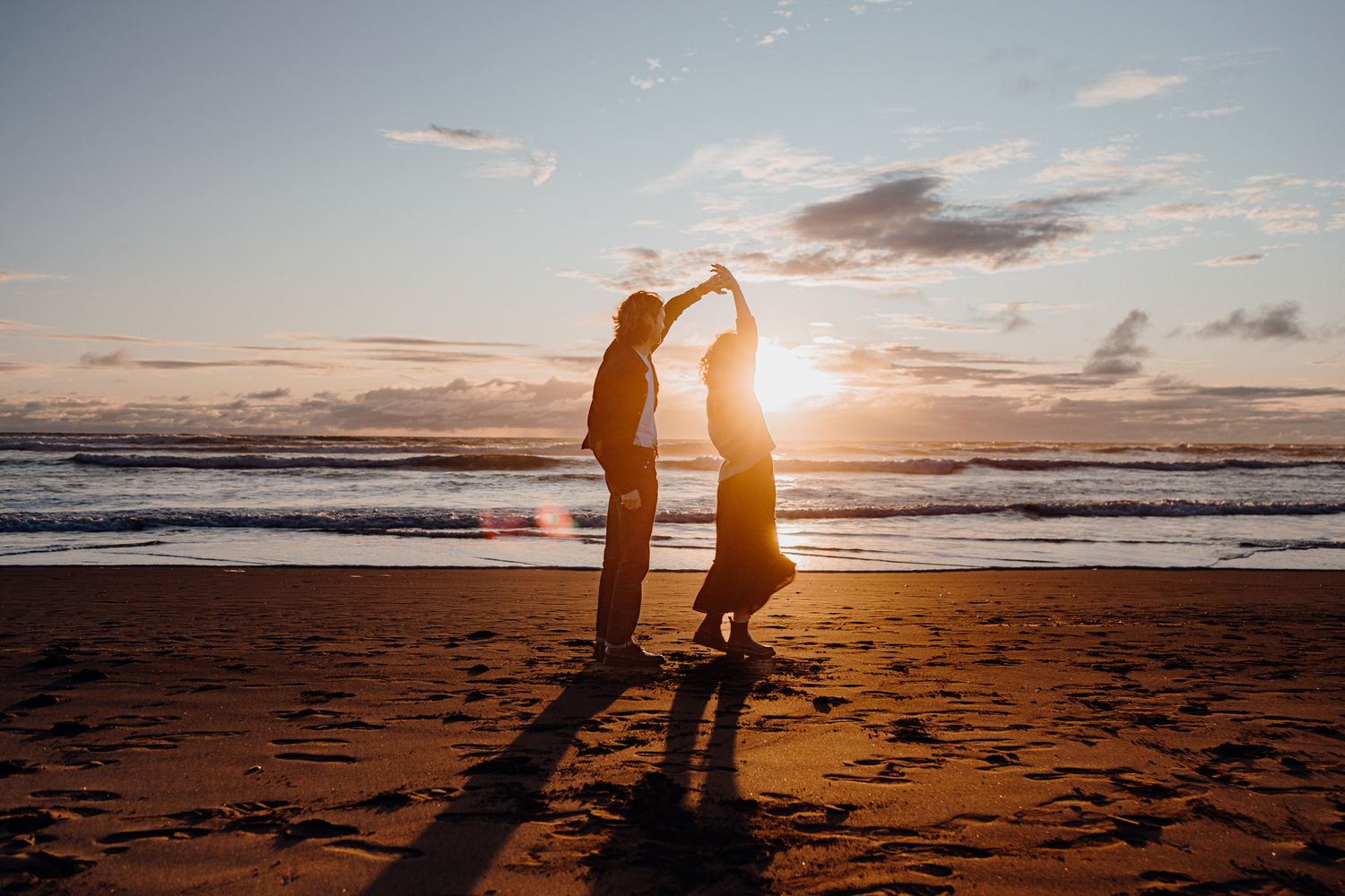 Dancing couple for their engagement shoot in Piha with Apertured Media-Auckland Wedding and Elopement Photographer