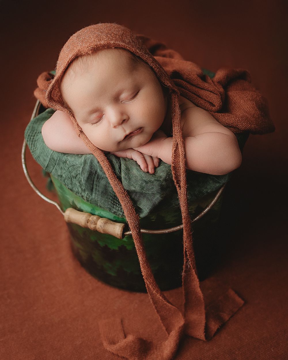 Professional newborn photo - baby in a bucket