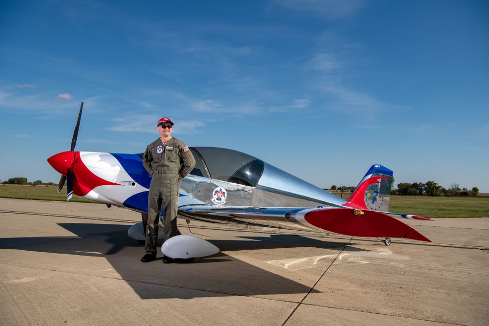 Man in flight suit with his airplane