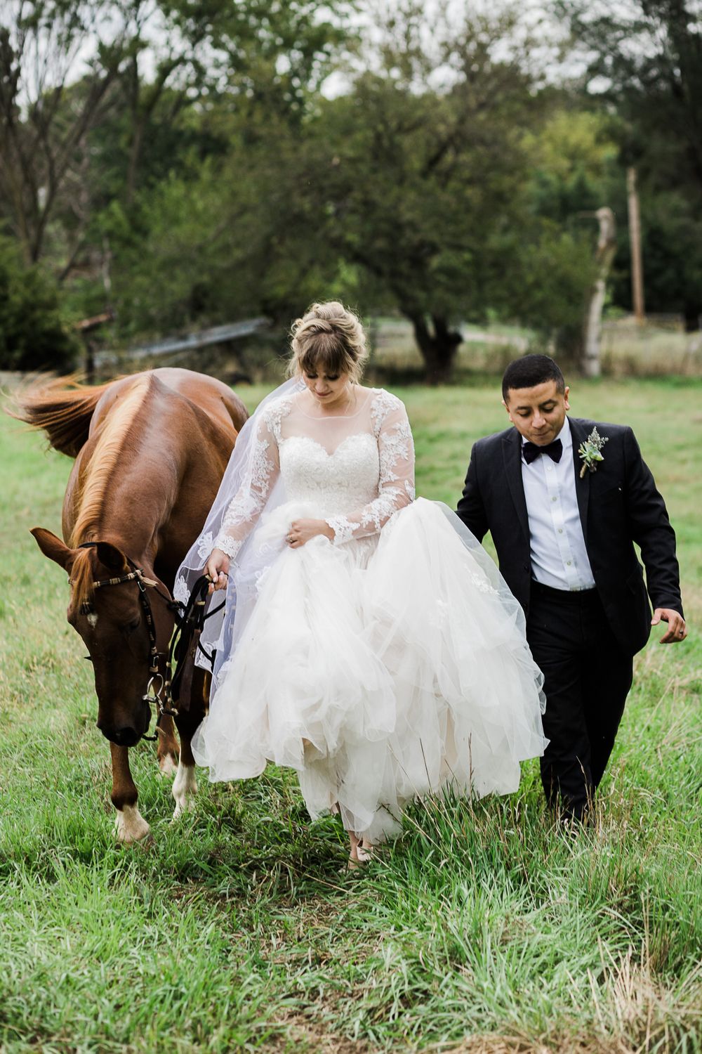 Bride and groom walking with horse by Hudson Valley wedding photographer
