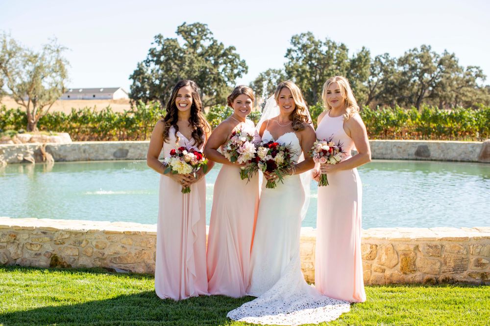 bride with bridesmaids near fountain at Rava Winery