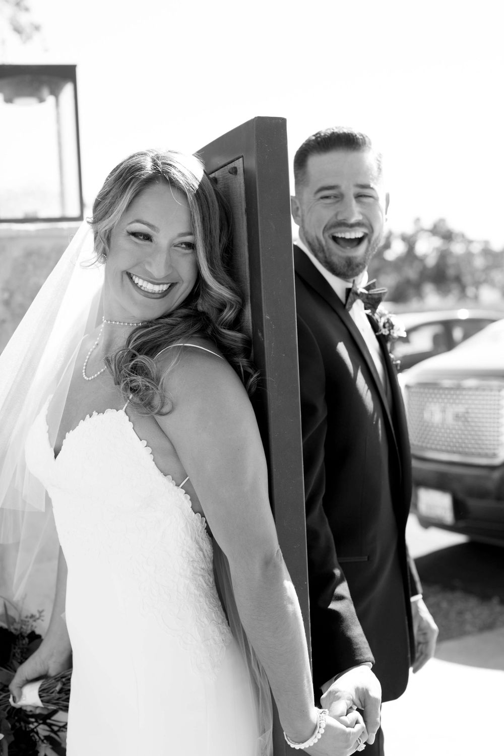 bride and groom on opposite sides of gate at Rava Winery