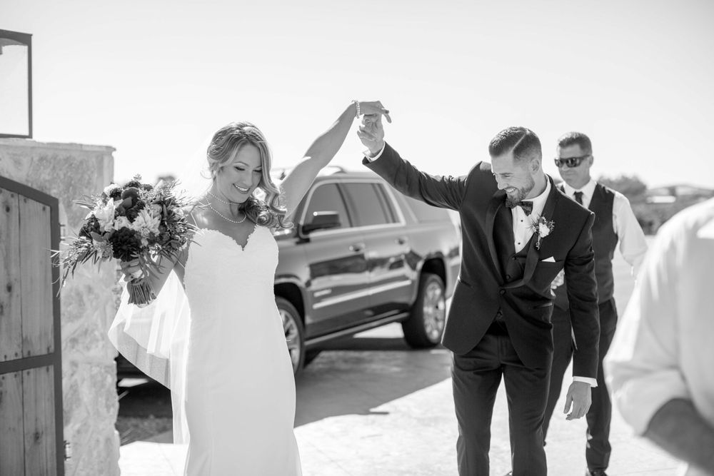 groom twirling bride during first look at Rava Winery