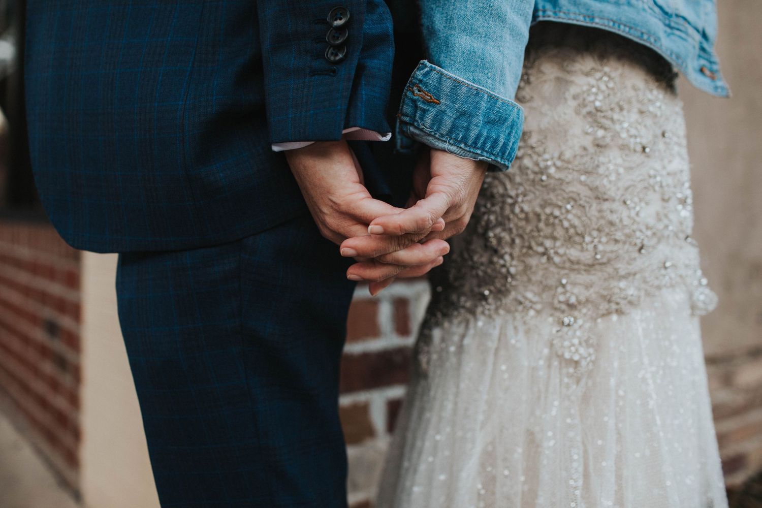 Couple holding hands outside of Uptown Brewery before their wedding in Greenville, NC.