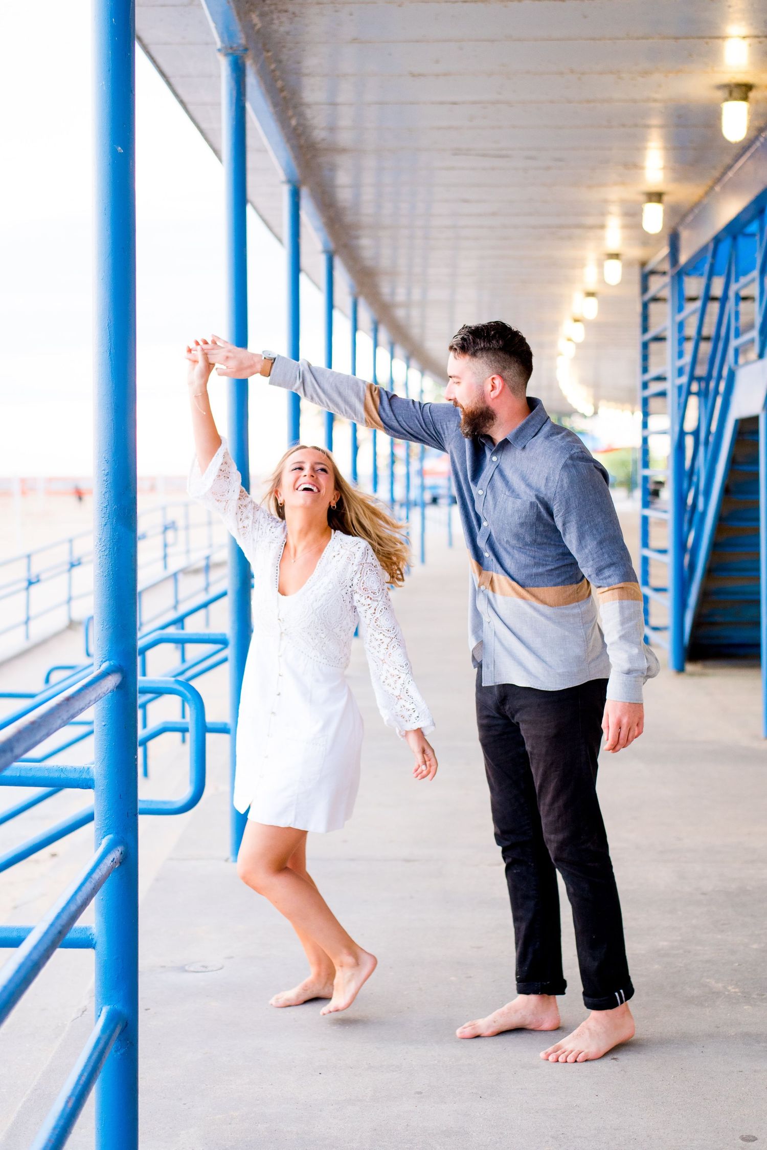 barefoot man and woman dance and spin around under the lights at North Avenue Beach