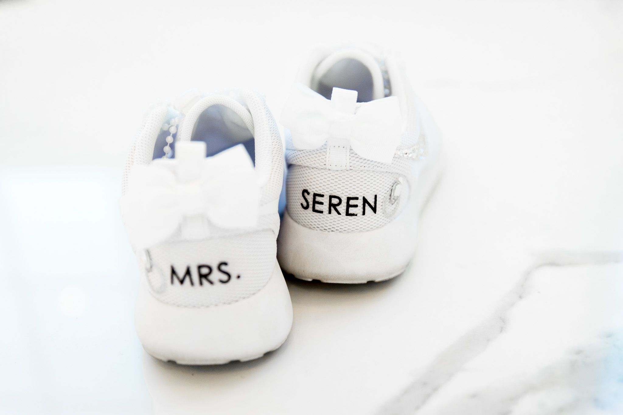 brides tennis shoes with white bows and sparkly jewels worn at chicago wedding