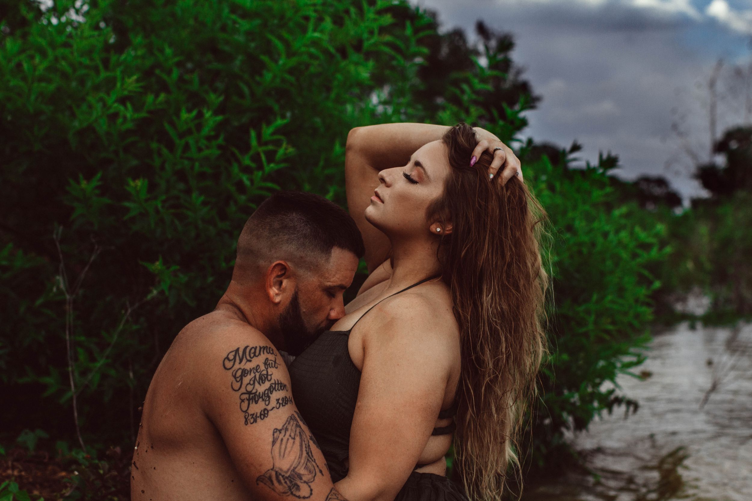couples posing for boudoir photos in a lake at Grapevine Tx