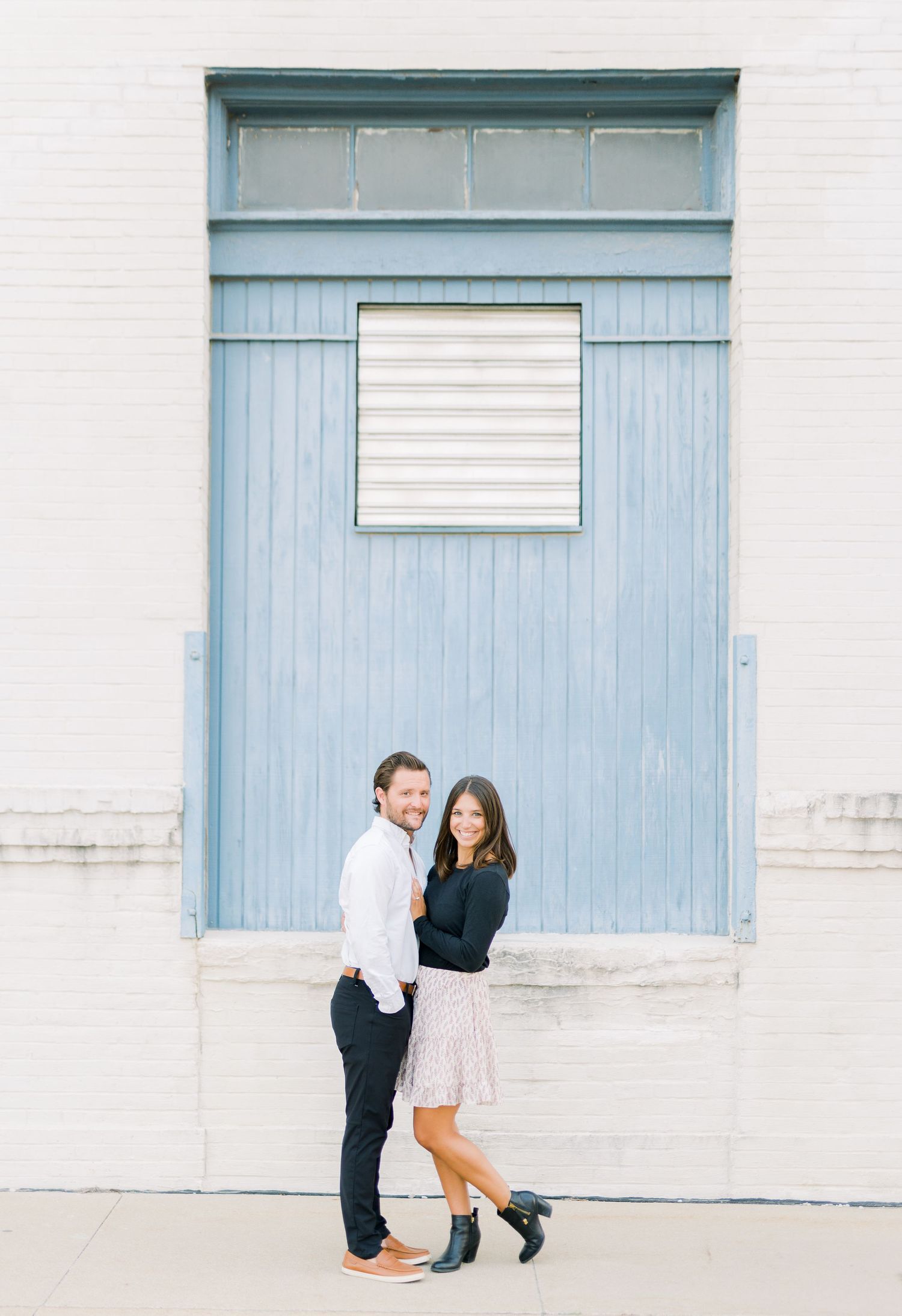 Des Moines Engagement photos in downtown Des Moines, Iowa with light and airy photographer Nicole Laing