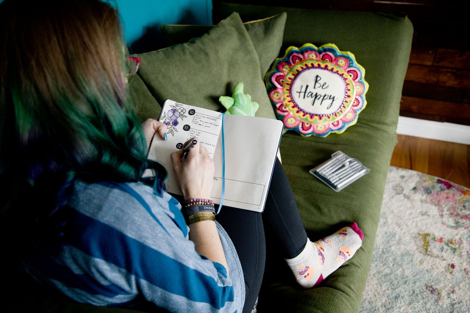 woman owned lifestyle branding session bullet journaling on couch at home in Auburn WA