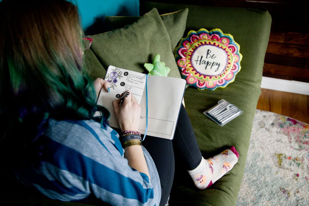woman owned lifestyle branding session bullet journaling on couch at home in Auburn WA