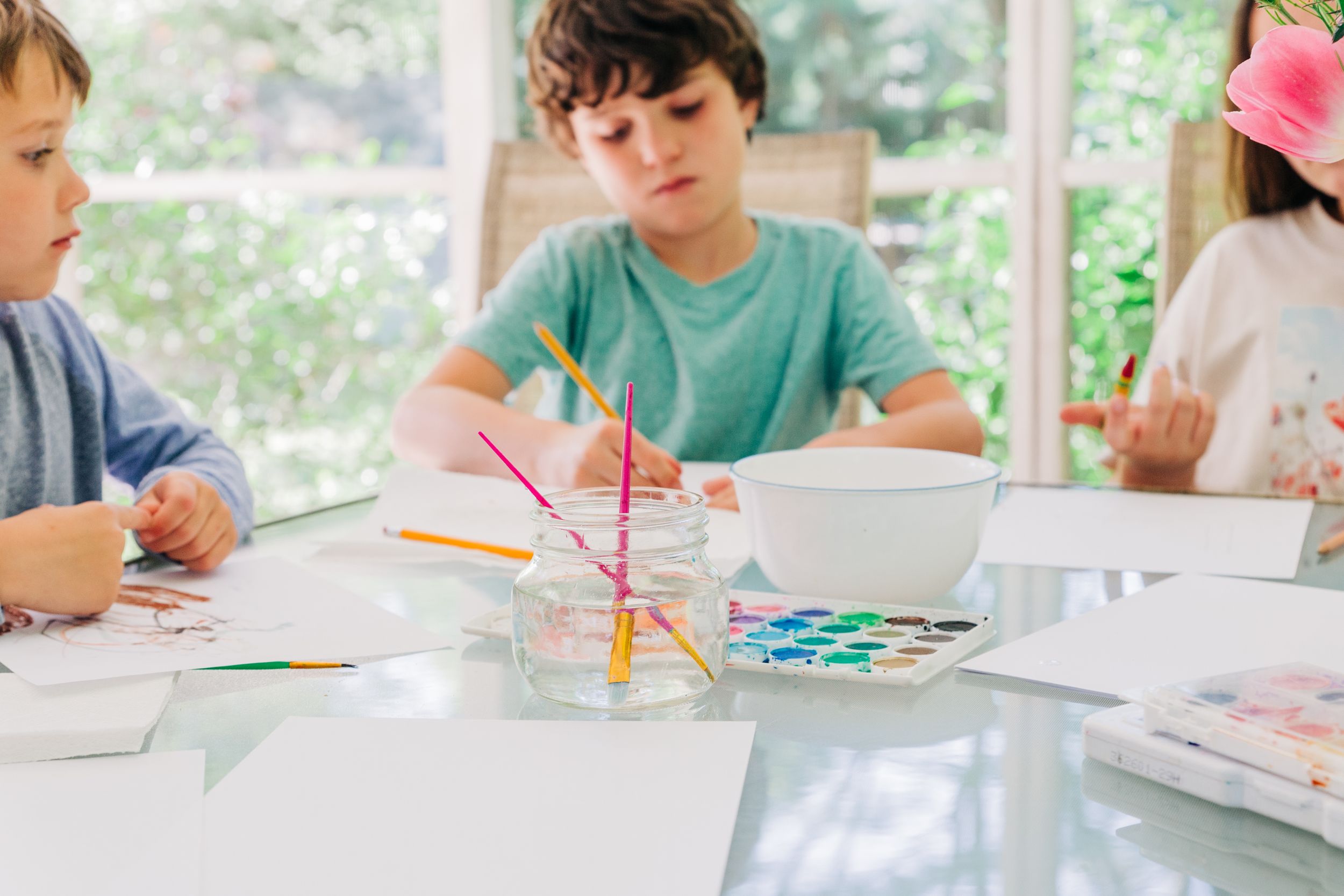 Paintbrushes on the table while children do watercolors