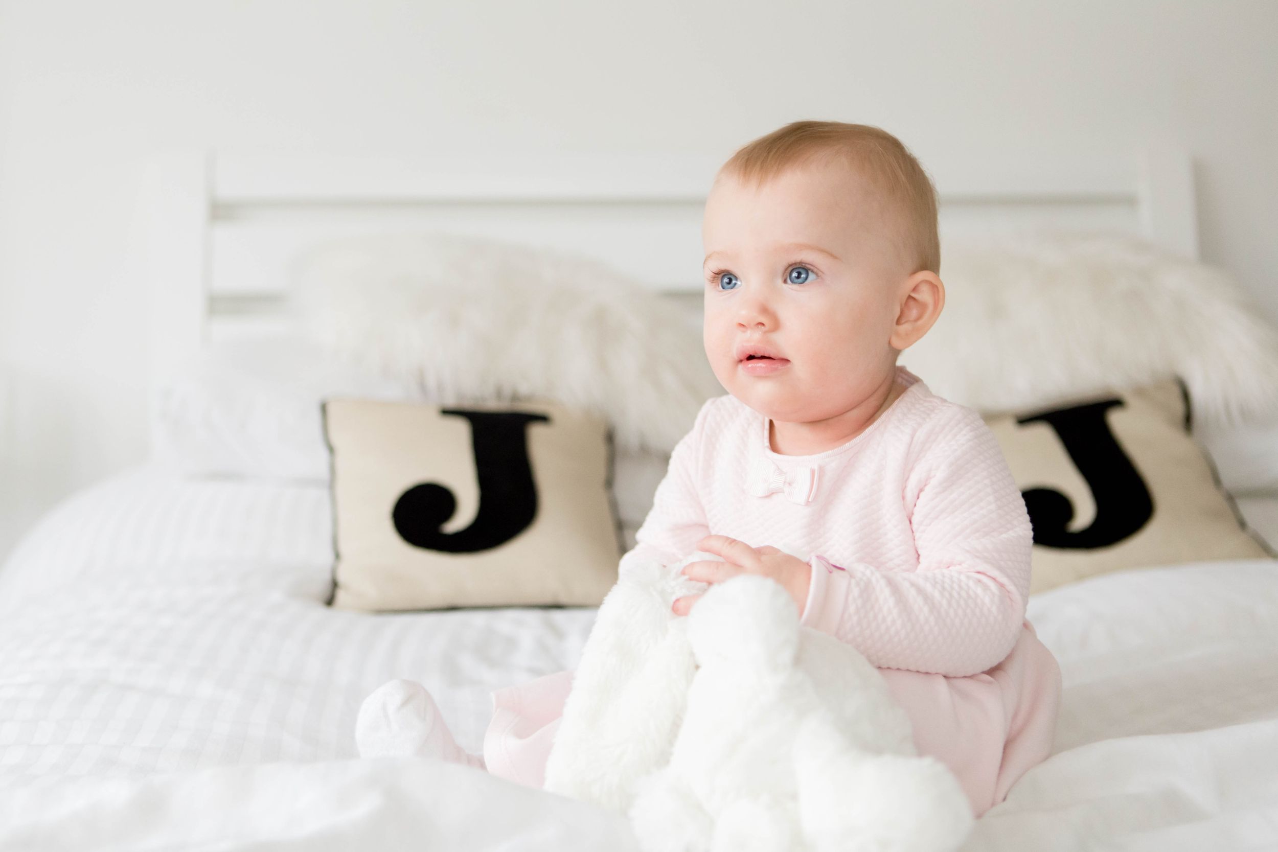 1 year old baby girl in pale pink dress