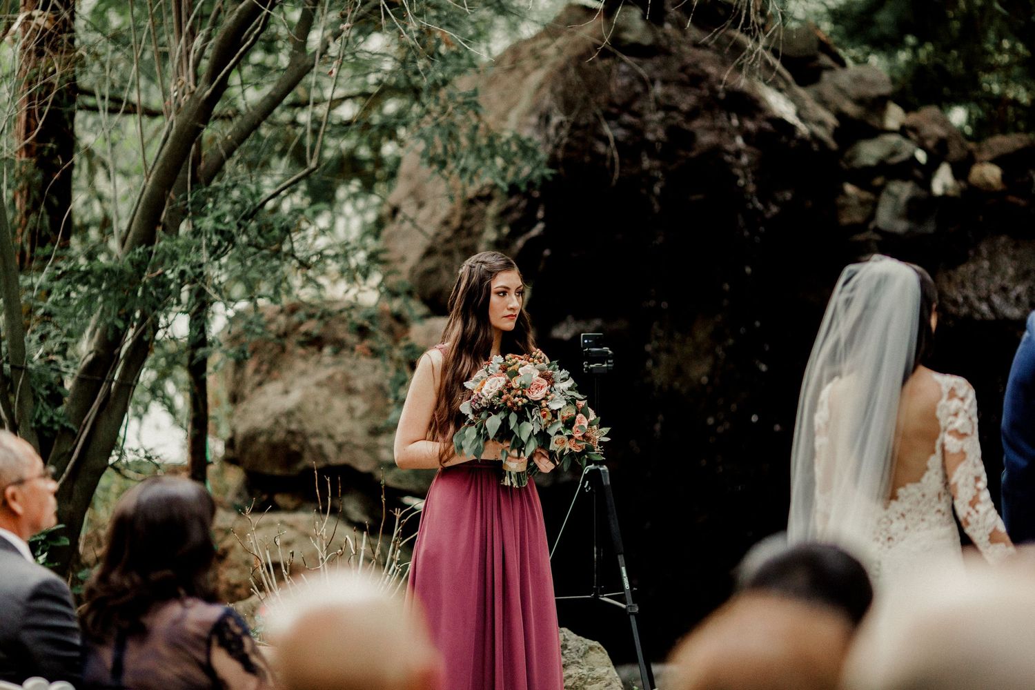 maid of honor standing at altar with bride and groom