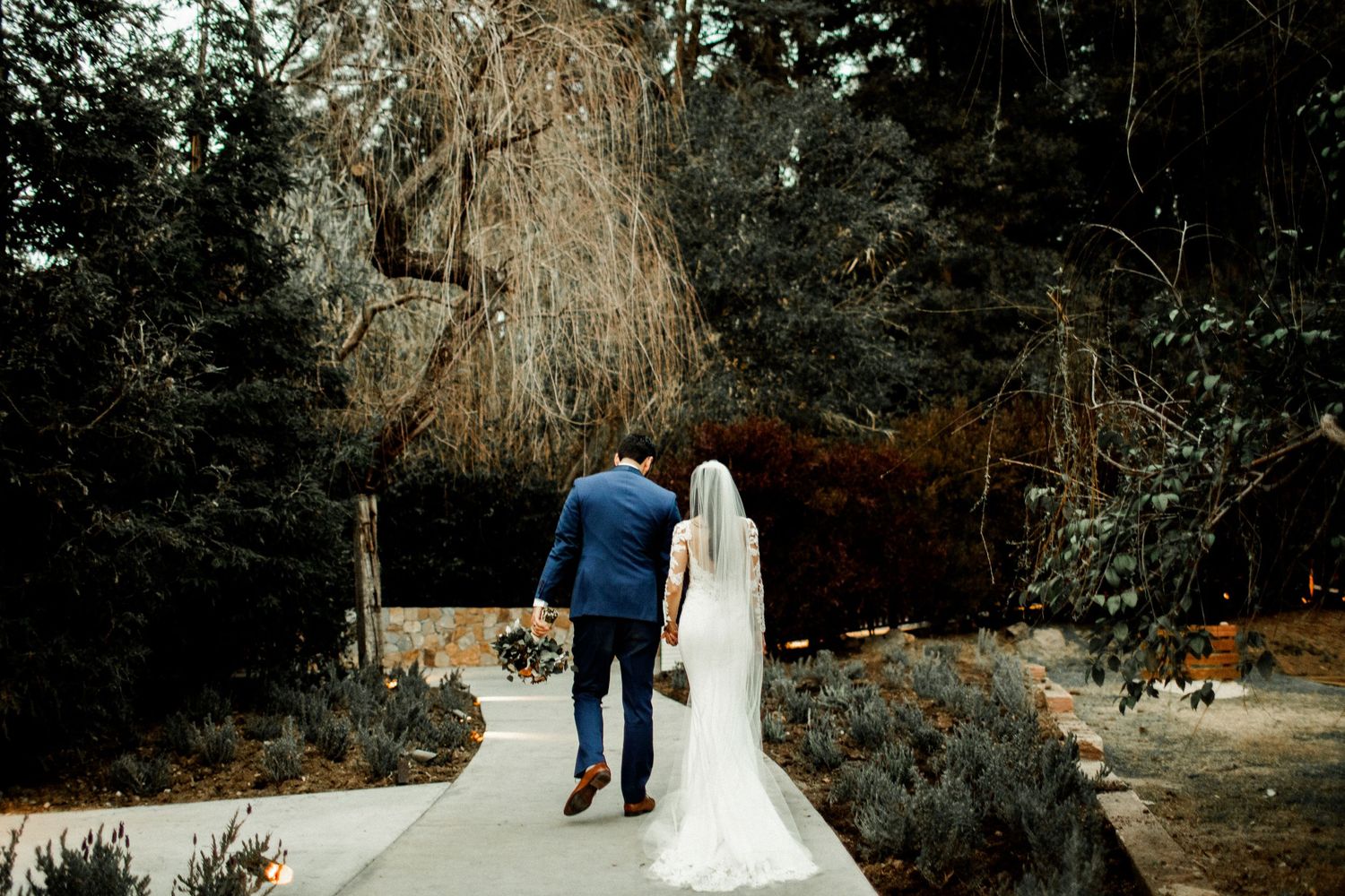 bride and groom walking away wide shot