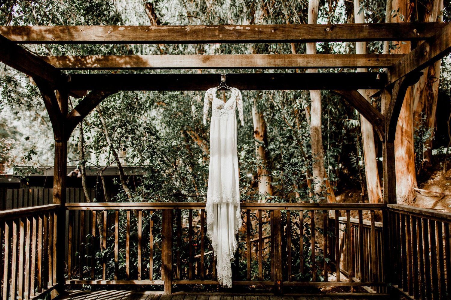 bride's wedding dress hanging on porch at calamigos ranch malibu