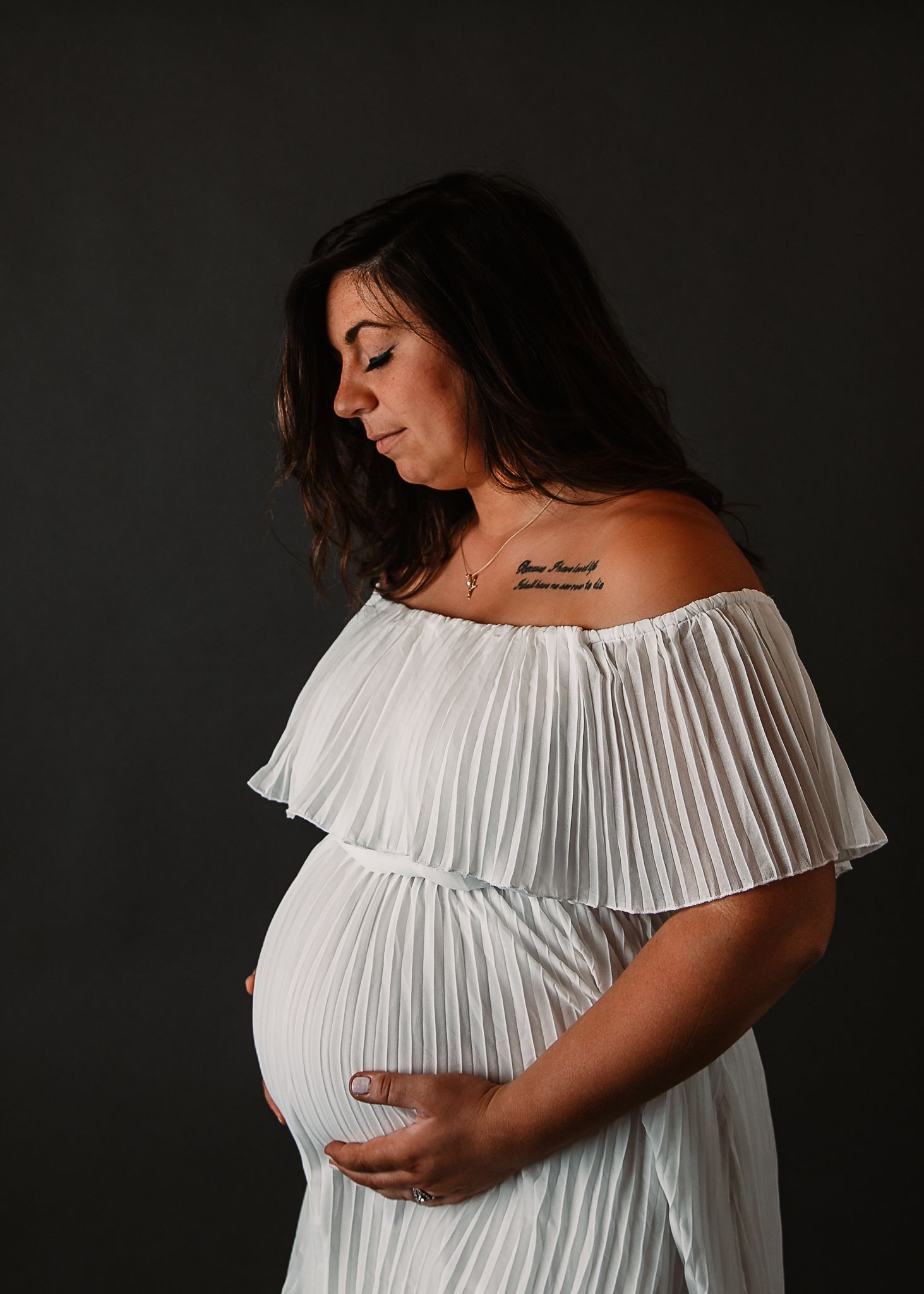white maternity dress studio session hands on stomach pictures