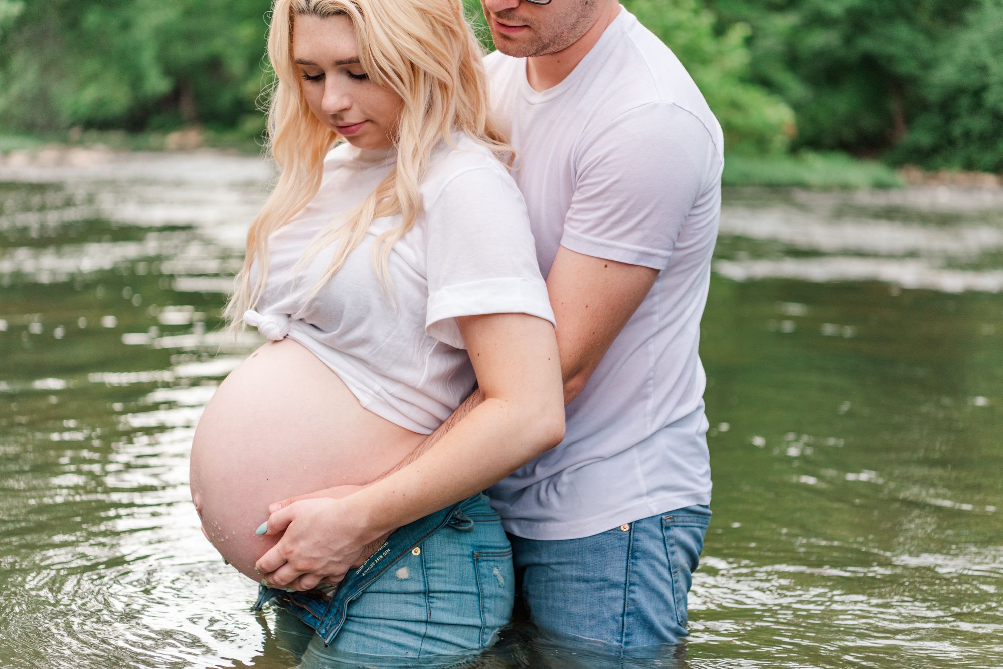 Casual maternity photos in jeans and white shirt in stream in Zelienople, Pennsylvania