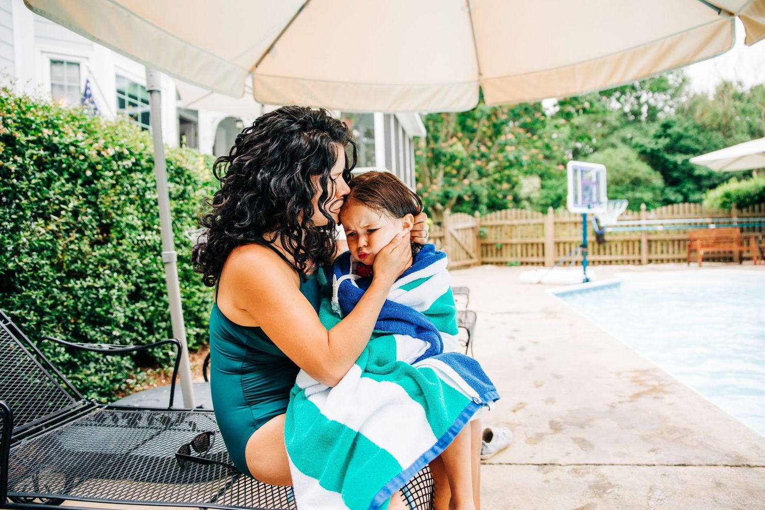 Mom and daughter sitting by their pool in Charlotte, NC backyard family photos