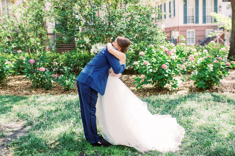 bride and groom hug during their monterey square first look in downtown savannah, ga