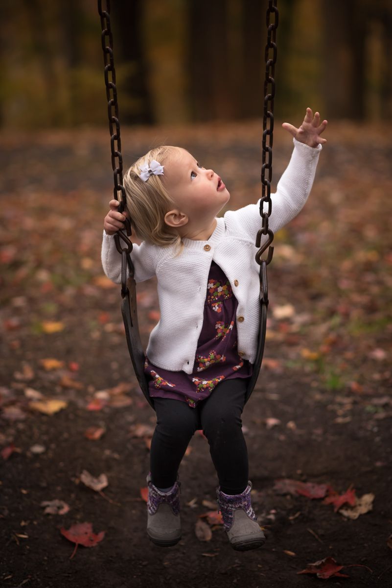 Autumn Portrait of a little girl sitting on a swing, taken by Laura Priestley in Morgantown, WV