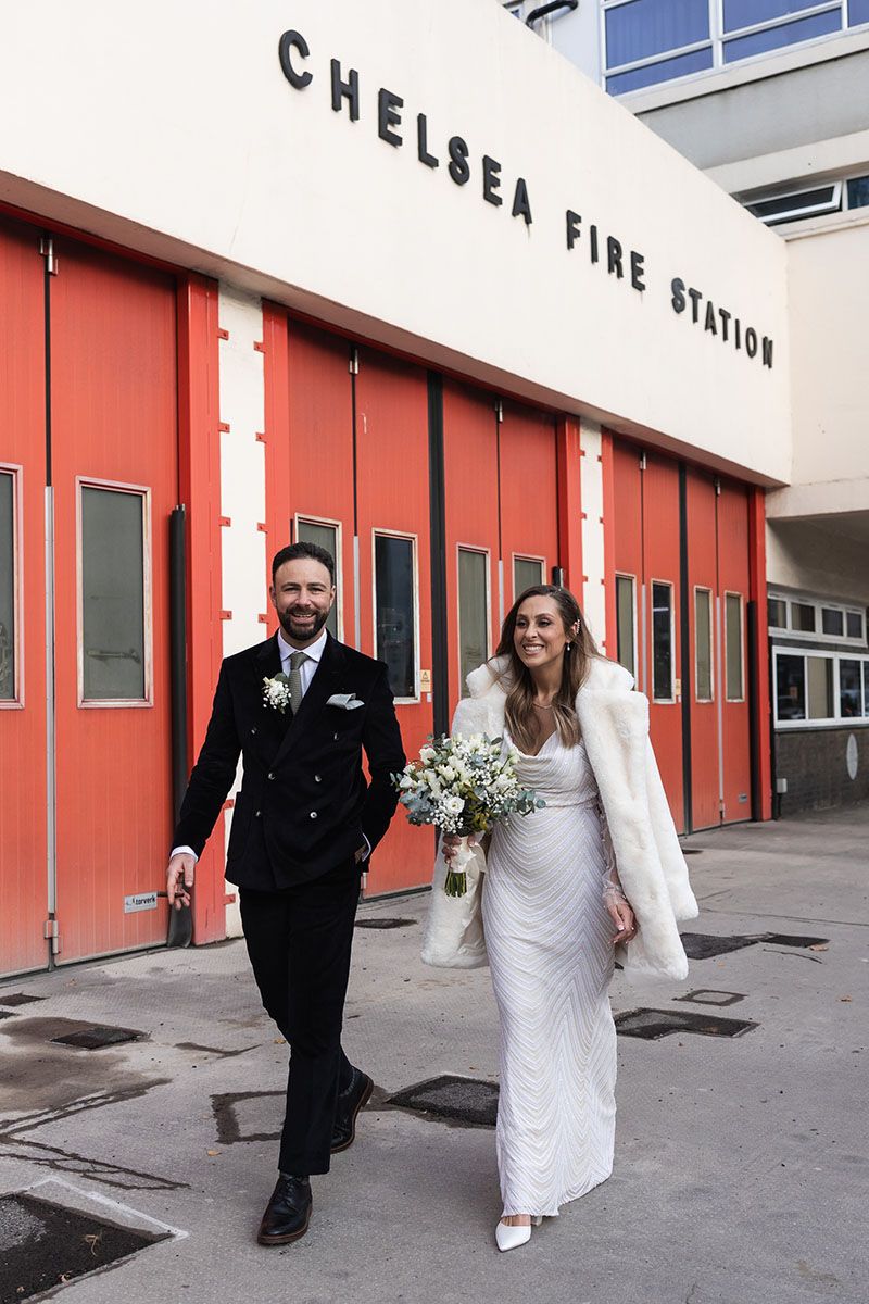 Relaxed couple wedding photography, walking past Chelsea Fire Station.