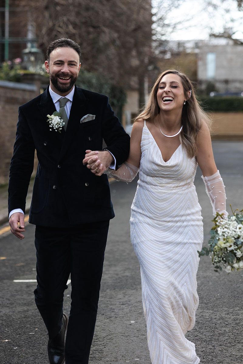 Candid couple photo, walking hand in hand, in London.