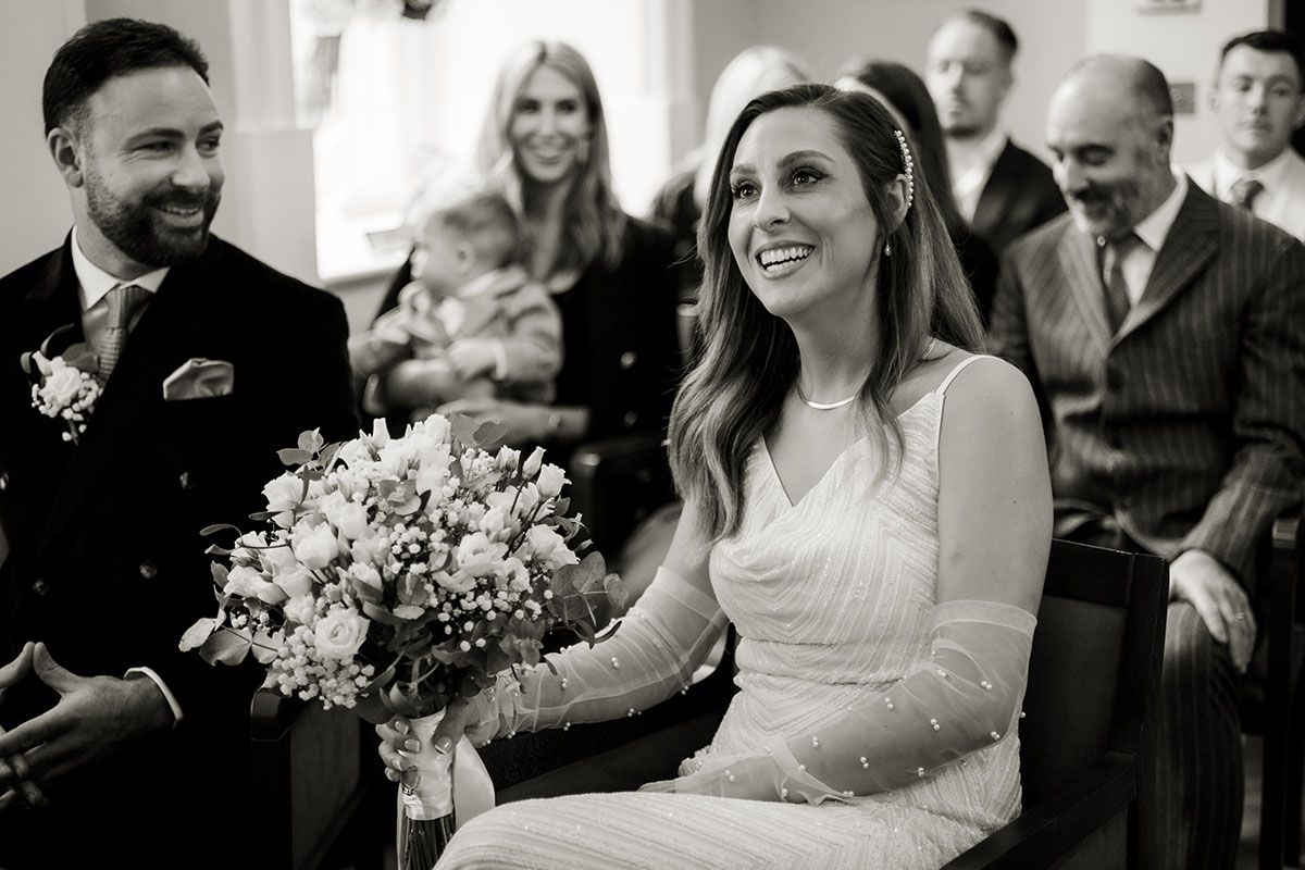 Candid photograph of smiling bride in Rosetti room - London