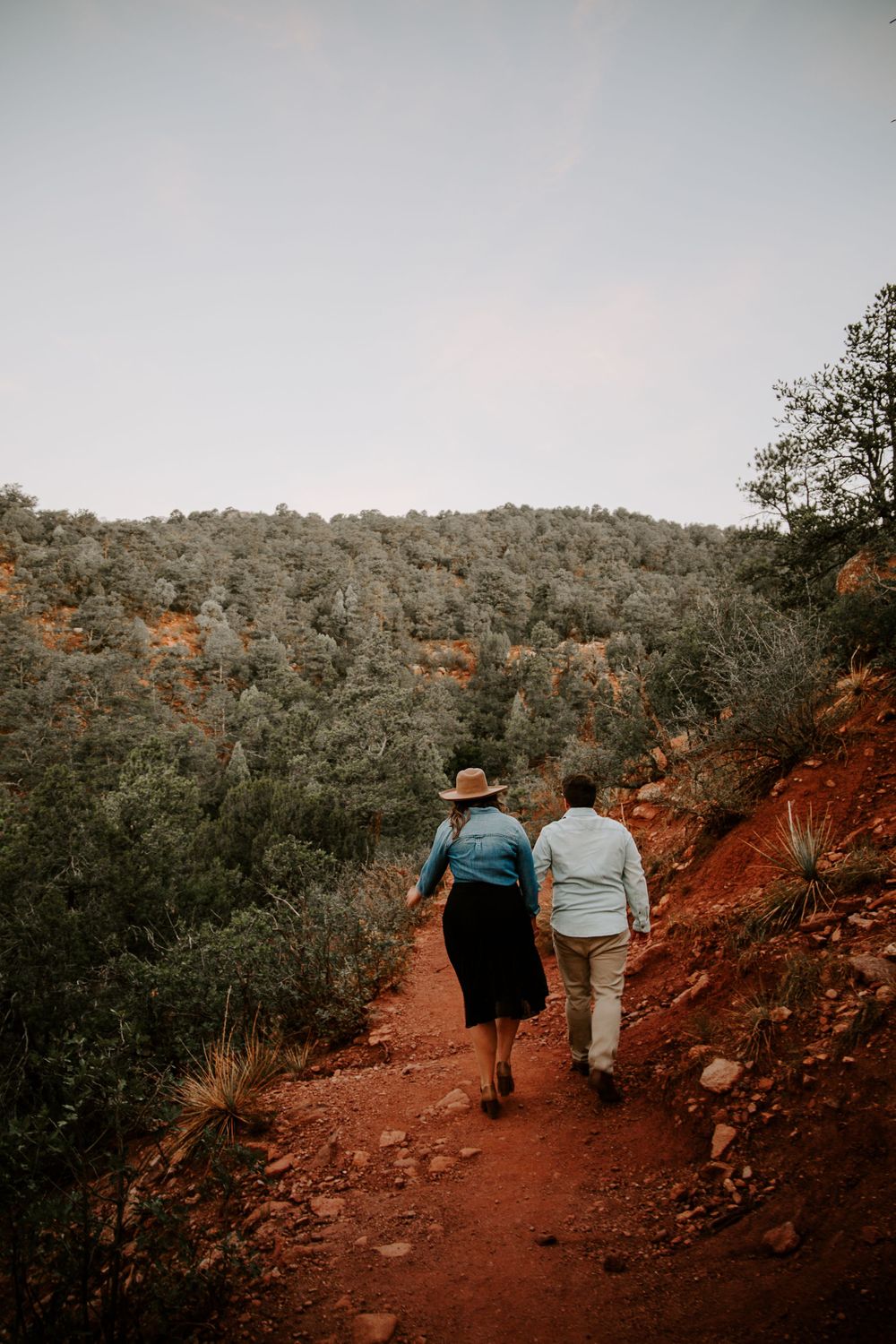 newly engaged couple hiking in garden of the gods