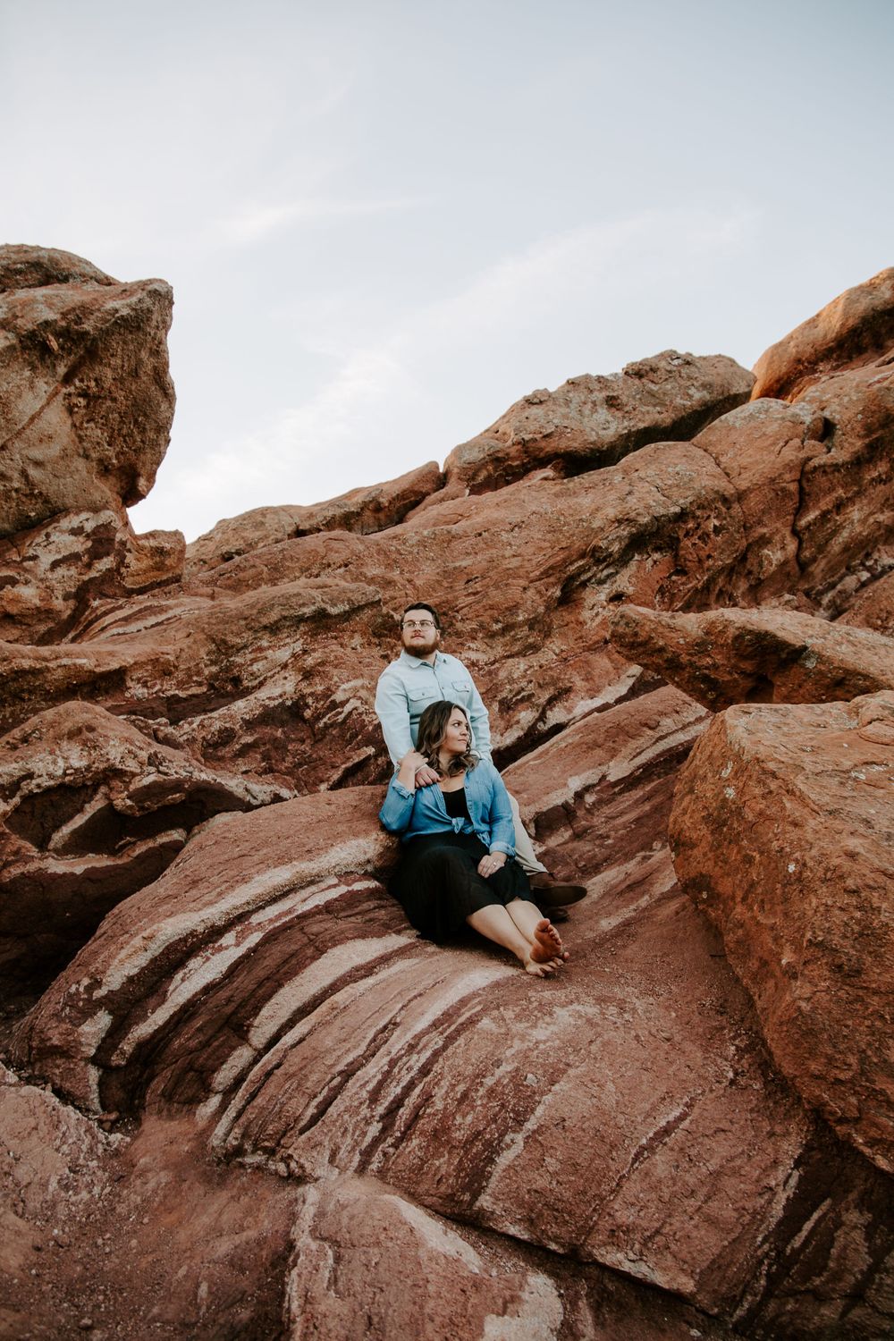 couple sitting on rocks in garden of the gods